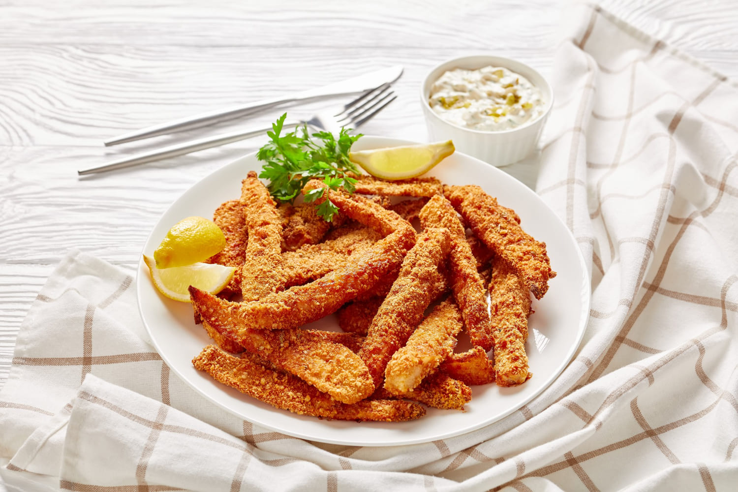 Golden crispy halloumi fries served on a plate with dipping sauces